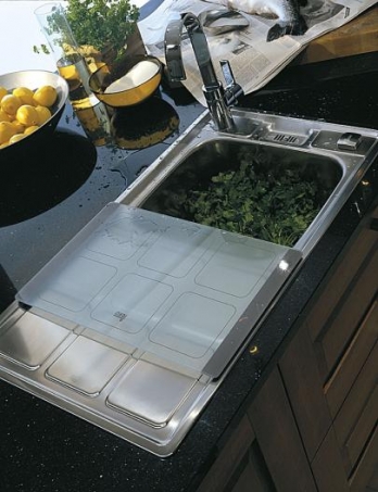 Stainless steel sink fitted with a worktop cover and colander